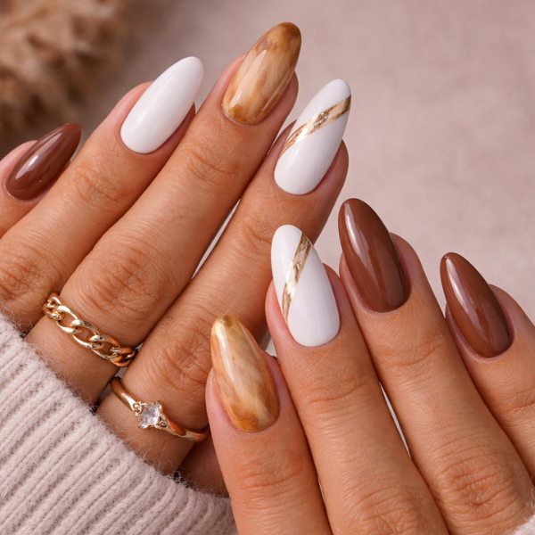 Caramel Marble brown white almond press on nails with marble design and gold accents on model hands