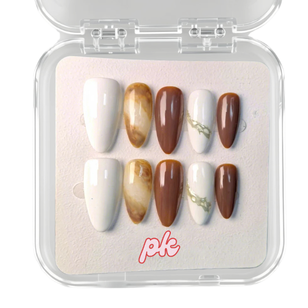 Caramel Marble brown white almond press on nails with marble design and gold accents on model hands