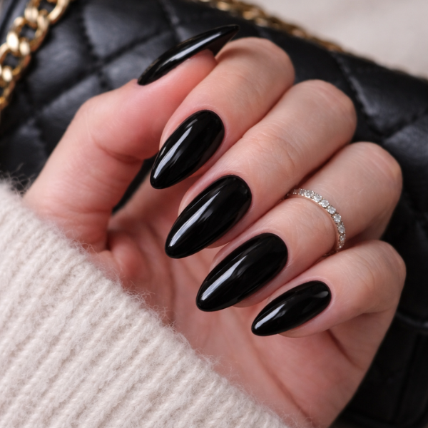Midnight Luxe glossy black almond press on nails on model hands